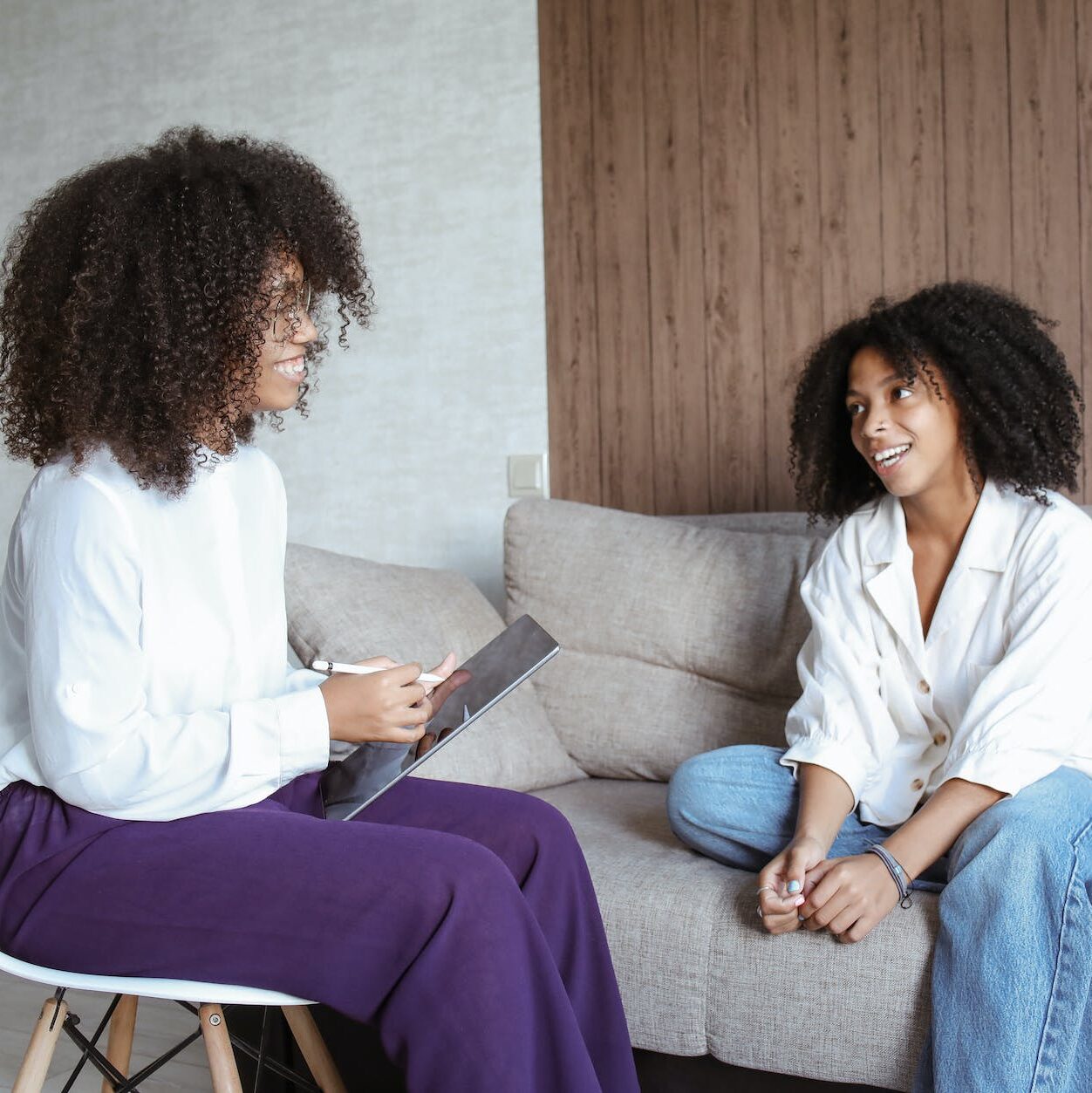 woman having conversation with other woman patient